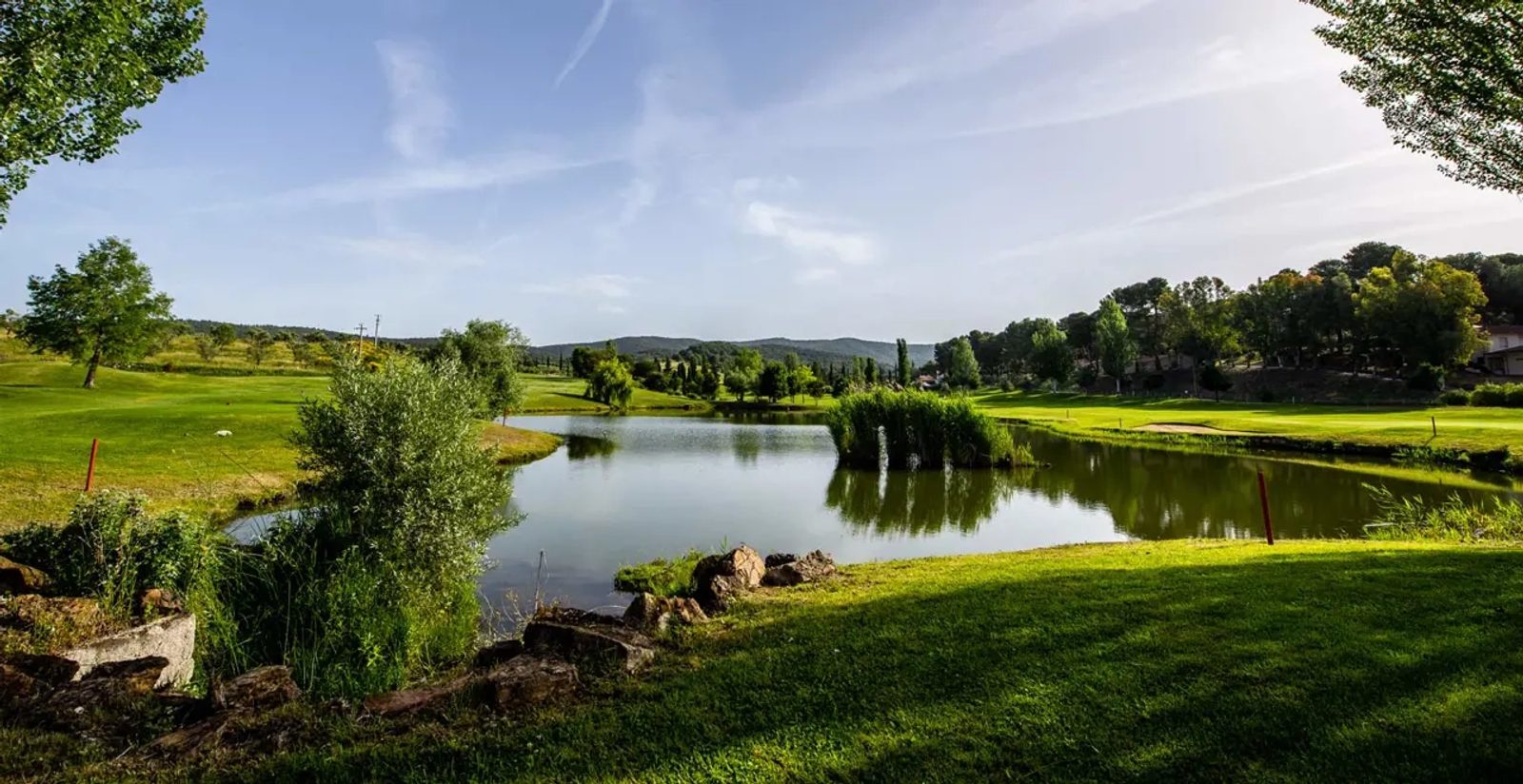 The course among cypresses and olive groves
